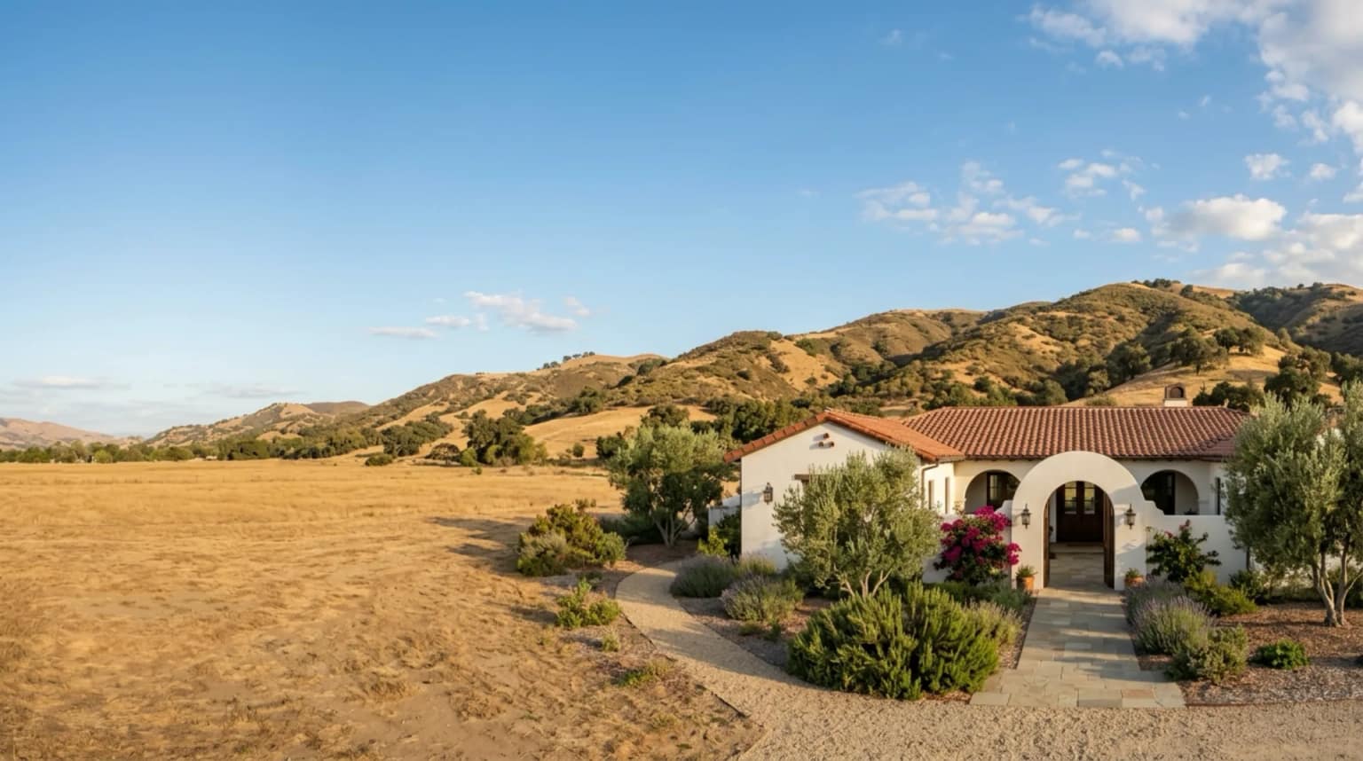 A hacienda-style home with a terracotta roof in inland California